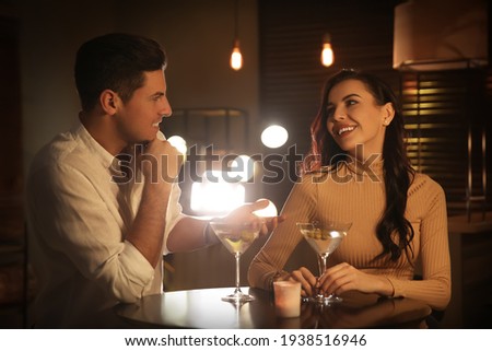 Man and woman flirting with each other in bar Royalty-Free Stock Photo #1938516946