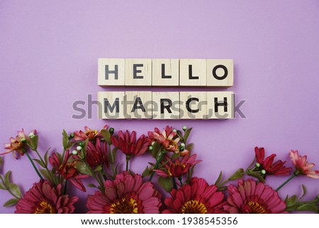 Hello March alphabet letters with pink flower decoration on purple background