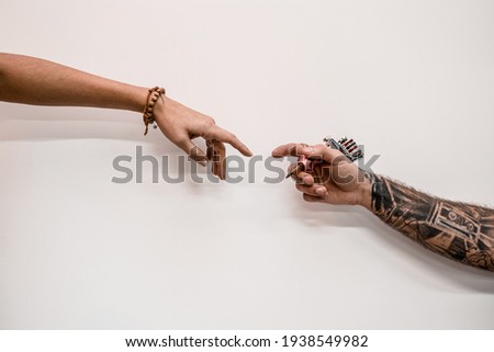 Close-up of two hands old-fashioned hipster tattoo artist holding tattoo machine on a white background. Royalty-Free Stock Photo #1938549982