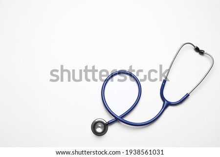 Stethoscope on white background, top view. Space for text Royalty-Free Stock Photo #1938561031