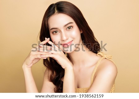 Asian woman are happy with perfect clean healthy skin and beautiful long brown hair. Cute female model clean fresh skin . Expressive facial expressions. Cosmetology concept. Royalty-Free Stock Photo #1938562159