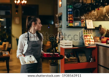 waitress working in cafe or restaurant Royalty-Free Stock Photo #1938563911