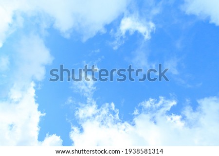 White clouds on the blue sky for background.