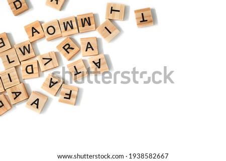Top view of square wooden tiles with the English alphabet scattered on a white background with space for text. The concept of thinking development, grammar. Royalty-Free Stock Photo #1938582667
