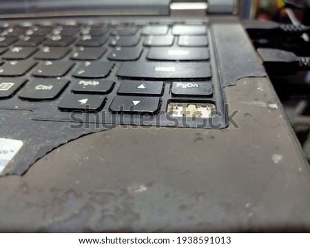 The keyboard keys on the laptop are damaged