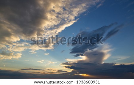 dramatic dark sky with rays and white clouds at sunset 2021