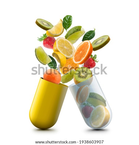 vitamin c pill open with citrus fruits jumping out Royalty-Free Stock Photo #1938603907