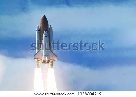 Rocket launch into open space. Elements of this image were furnished by NASA. Royalty-Free Stock Photo #1938604219