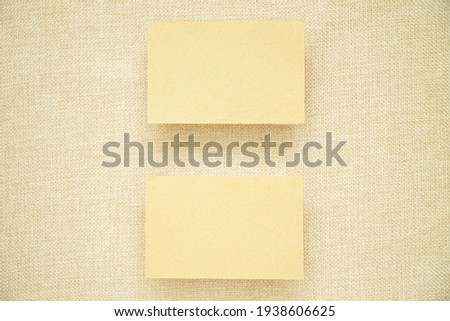 blank brown business card on beige linen.