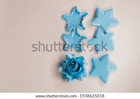 How to paper flower for make origami rose and leaves, handmaed  romantic bouquet for valentine, wedding, card, and decorate backdrop. Focus blue rose paper on the white background.
