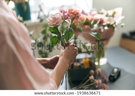 Gardener s in the flower shop make bouquet for a holiday. Lifestyle flower shop. Beautiful flower composition. Detail. Close up. Royalty-Free Stock Photo #1938638671