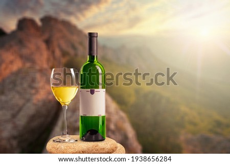 Wineglass With tasty wine on the desk on nature background