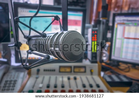 Professional microphone and sound mixer in radio station studio Royalty-Free Stock Photo #1938681127