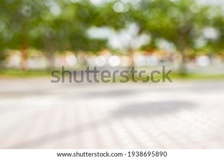 BLURRED CITY STREET WITH GREEN TREES IN CITY PARK, URBAN BACKGROUND 