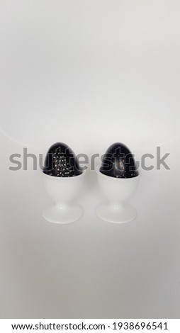 Easter decorative eggs in a stand on a light surface. High quality photo
