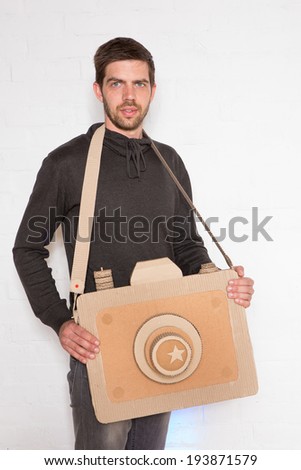 cheerful man with a handmade cardboard camera