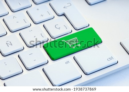Online shopping, ecommerce, internet shopping concept. Shopping cart icon on green keyboard key