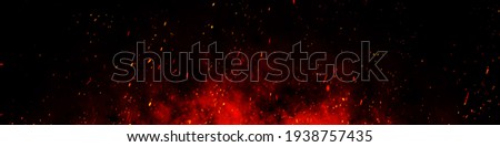 Fire embers particles over black background. Fire sparks background. Abstract dark glitter fire particles lights. bonfire in motion blur. Royalty-Free Stock Photo #1938757435