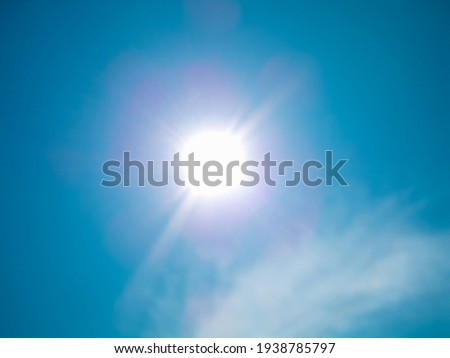 Bright blue sky and sunshine with glints of sunlight Royalty-Free Stock Photo #1938785797