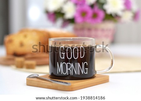 Cup of coffee with text good morning with tasty homemade cake and flowers. 