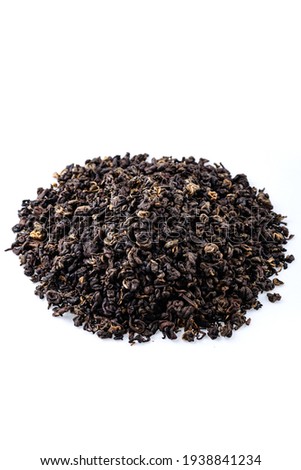 Heap of black tea on a white background. Dry black tea leaves isolated on white background, delicious, natural. Flat lay.