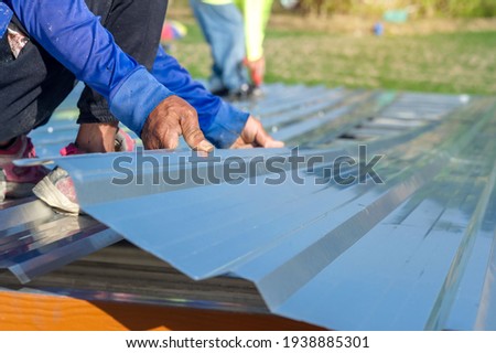 
Roofing workers used metal sheets on the roof of the house. Royalty-Free Stock Photo #1938885301