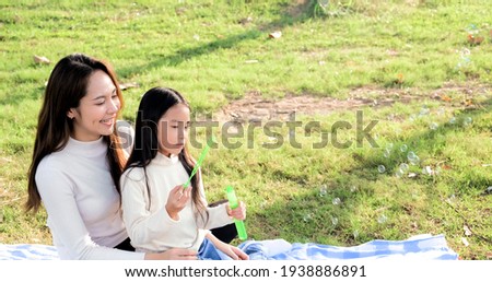 Asian portrait family trip father mother and daughter enjoy relaxation Blowing bubbles with family to lifestyle freedom family vacation caucasian asian.one day trip new normol togetherness