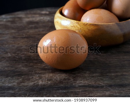 Fresh chicken eggs on the wooden table for cooking