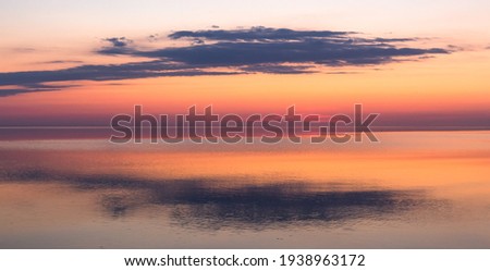 cloudscape  at sunset by the sea by the river and by the lake Royalty-Free Stock Photo #1938963172