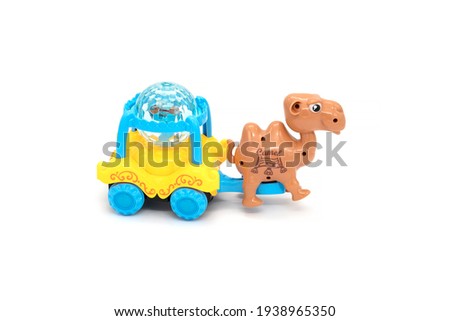 Plastic colorful camel with a carriage toy isolated white.