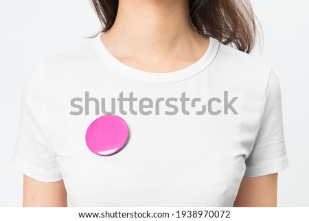 Pink empty badge pin on woman's t-shirt with design space Royalty-Free Stock Photo #1938970072