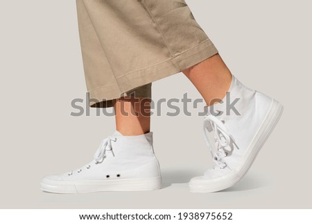 Basic white sneakers unisex streetwear fashion shoot Royalty-Free Stock Photo #1938975652