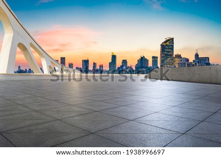 Empty square and city skyline at dusk in Shanghai.