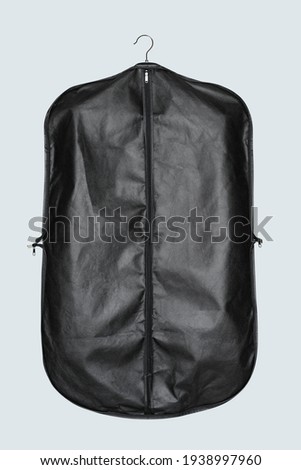 Black garment bag for suit storage and protection Royalty-Free Stock Photo #1938997960