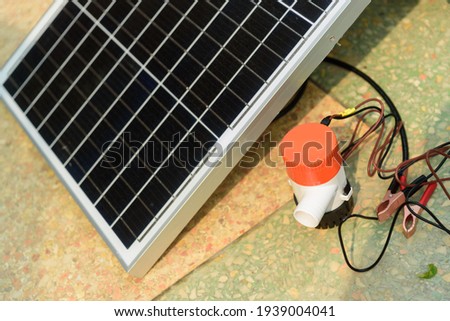 Testing bilge pump connected to use power from solar cell panel  Royalty-Free Stock Photo #1939004041