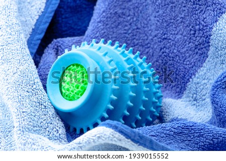Silicone ball dryer removes moss from clothes and prevents creasing of clothes when drying. Selective focus with shallow depth of field. 
