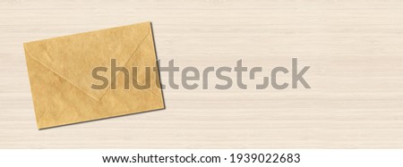 Brown paper enveloppe mockup template isolated on horizontal white wooden banner