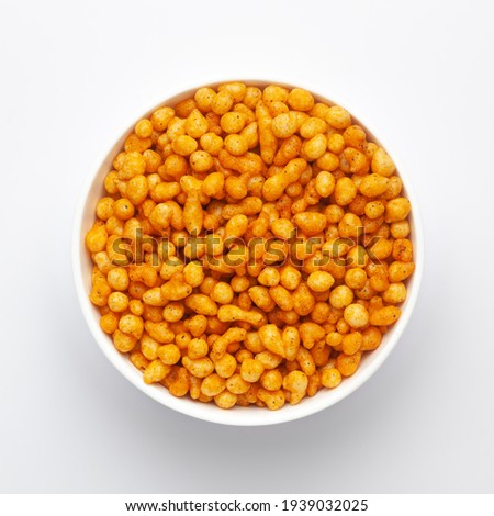 Close up of crunchy masala boondi Indian namkeen (snacks) on a ceramic white bowl. Top view Royalty-Free Stock Photo #1939032025