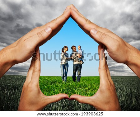 house made of hands protecting young family at the field Royalty-Free Stock Photo #193903625