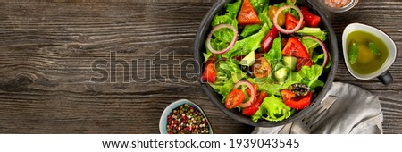 Fresh vegetables salad on wooden background. Healthy eating concept. Top view, copy space, panorama