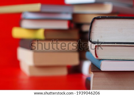Stack of books on red background