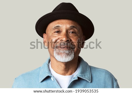Mature man smiling face closeup portrait on green background Royalty-Free Stock Photo #1939053535