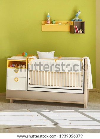 Green baby room with bed style, hanger toy carpet style.