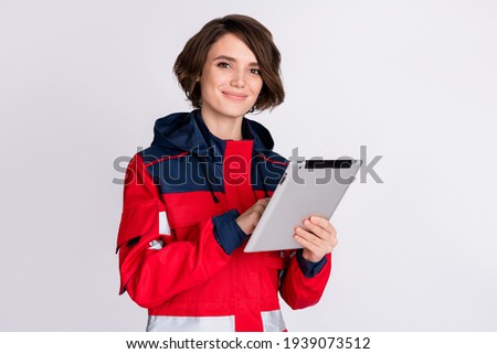 Photo of optimistic nice brunette lady write tablet wear uniform isolated on grey color background