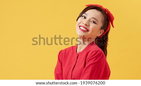 Beautiful asian woman standing over isolated yellow background with a happy and cool smile on face. Lucky person.