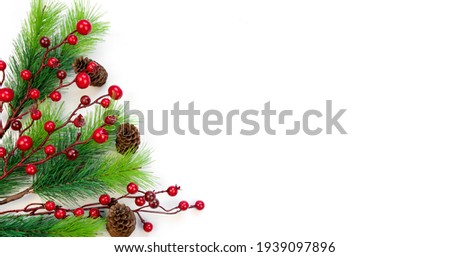New Year's composition. Christmas background top view on white background. Fir branches, red berries, cones. Place for your text