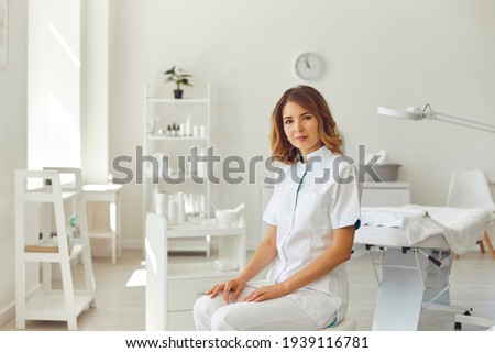 Woman cosmetologist or dermatologist looking at camera in beauty spa salon room Royalty-Free Stock Photo #1939116781