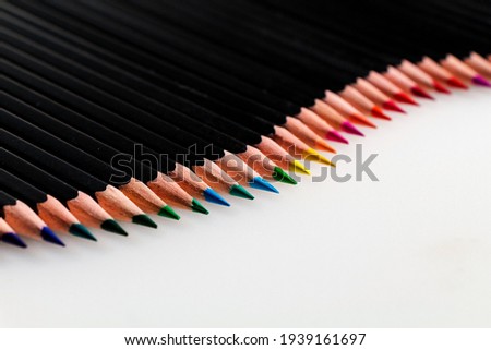 Collection of multicolored pencils on a white background.