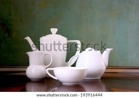 Teapots, creamer and cup