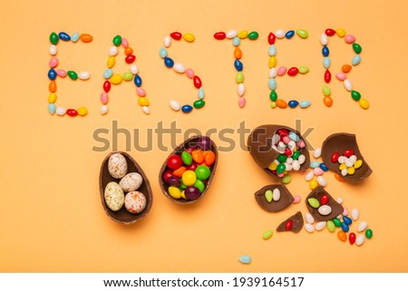 Colorful eggs with the word Easter wrote with sweet candies, free space for greeting text.